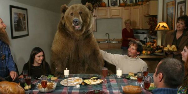 Friendly bear surrounded by human family