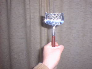 Handheld cheese grater